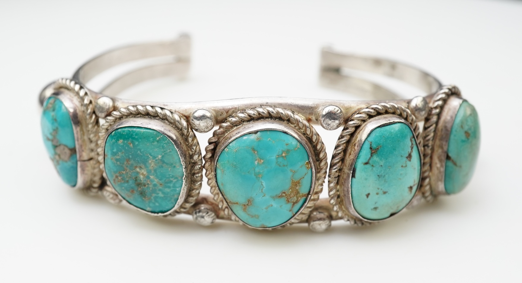 A collection of silver jewellery including a Zuni bangle